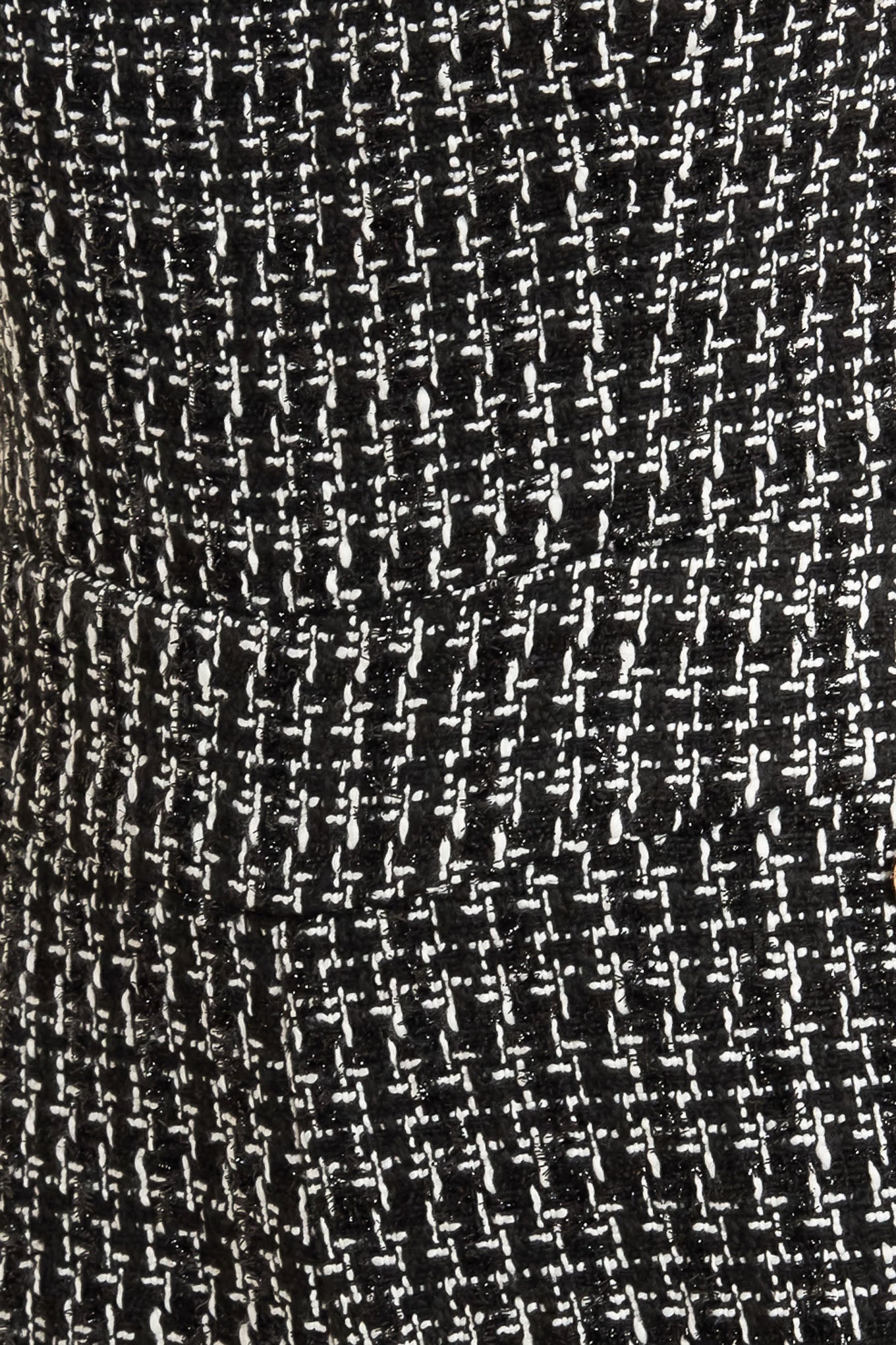 A tweed jumpsuit featuring strapless, side pockets with button detail, wide leg and back zipper closure