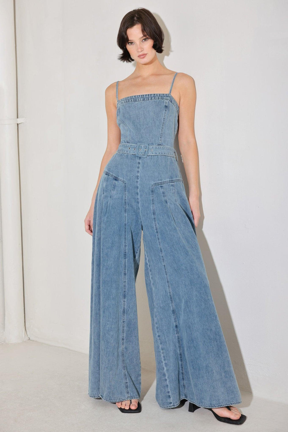 
A washed denim jumpsuit featuring straight neckline, straps, self belt, extra wide leg and back zipper closure

Details:

Self : 90.2% Cotton 4.8% Viscose 5% Polyester

Size &amp; Fit

- Model is 5`8" And Wearing Size Small
- Measurements Taken From Size Small
- Approx. Length: 60"
