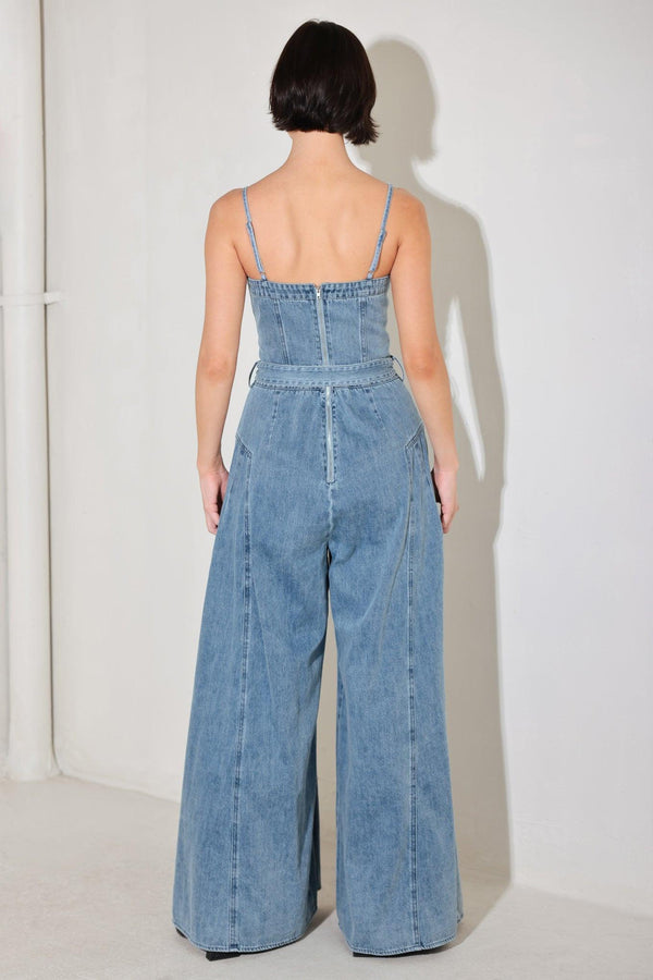 
A washed denim jumpsuit featuring straight neckline, straps, self belt, extra wide leg and back zipper closure

Details:

Self : 90.2% Cotton 4.8% Viscose 5% Polyester

Size &amp; Fit

- Model is 5`8" And Wearing Size Small
- Measurements Taken From Size Small
- Approx. Length: 60"