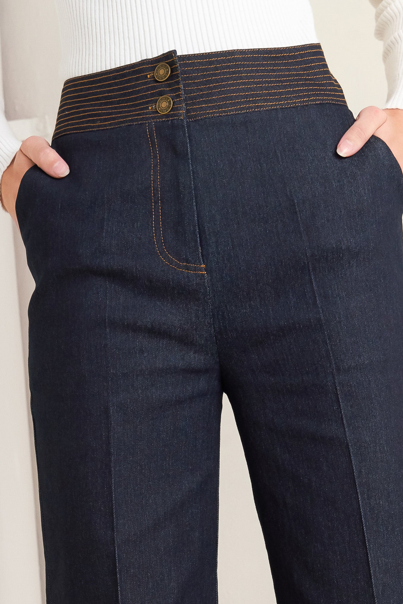 A denim pant featuring front closure, wide waistband with stitching detail, side pocket and wide leg.