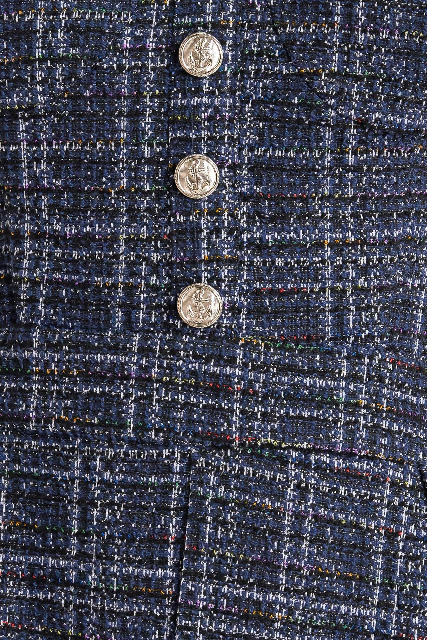 A tweed jumpsuit featuring sweetheart neckline, front button detail, side pockets and back zipper closure