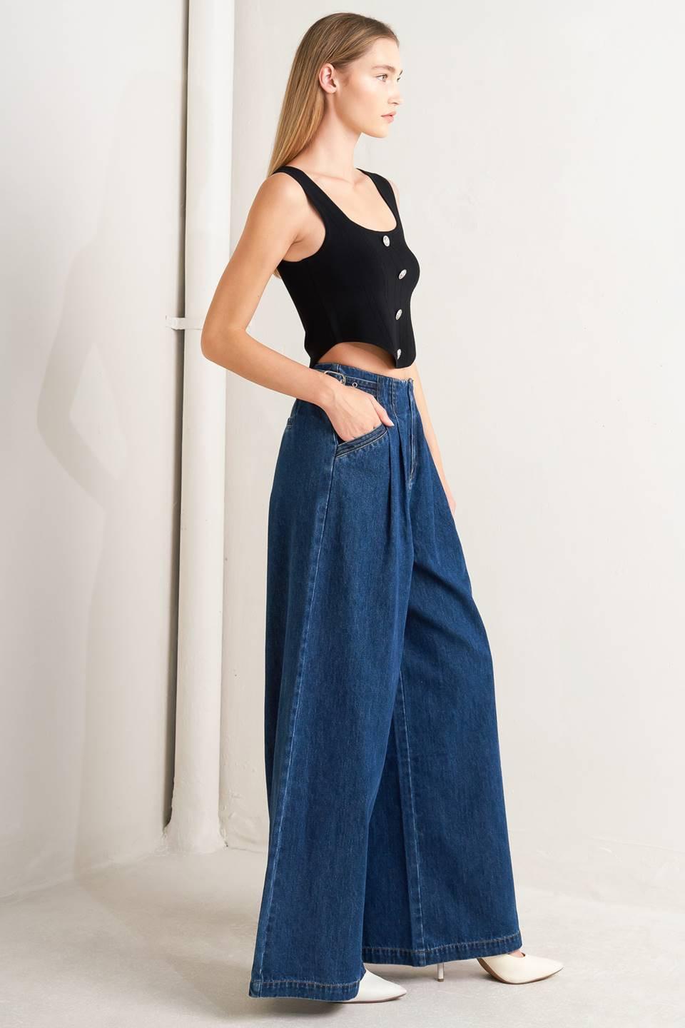 A denim pant featuring front closure, side buckle detail, pockets and wide leg.