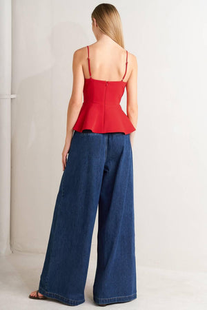 A denim pant featuring front closure, side buckle detail, pockets and wide leg.