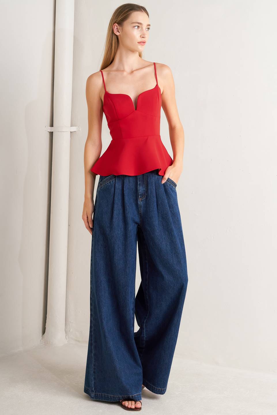 A denim pant featuring front closure, side buckle detail, pockets and wide leg.