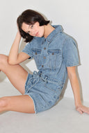 
A washed denim romper featuring collar, button down, short sleeve pockets and self tie

Details:

Self : 90% Cotton 10% Polyester

Size &amp; Fit

- Model is 5`8" And Wearing Size Small
- Measurements Taken From Size Small
- Approx. Length: 33"