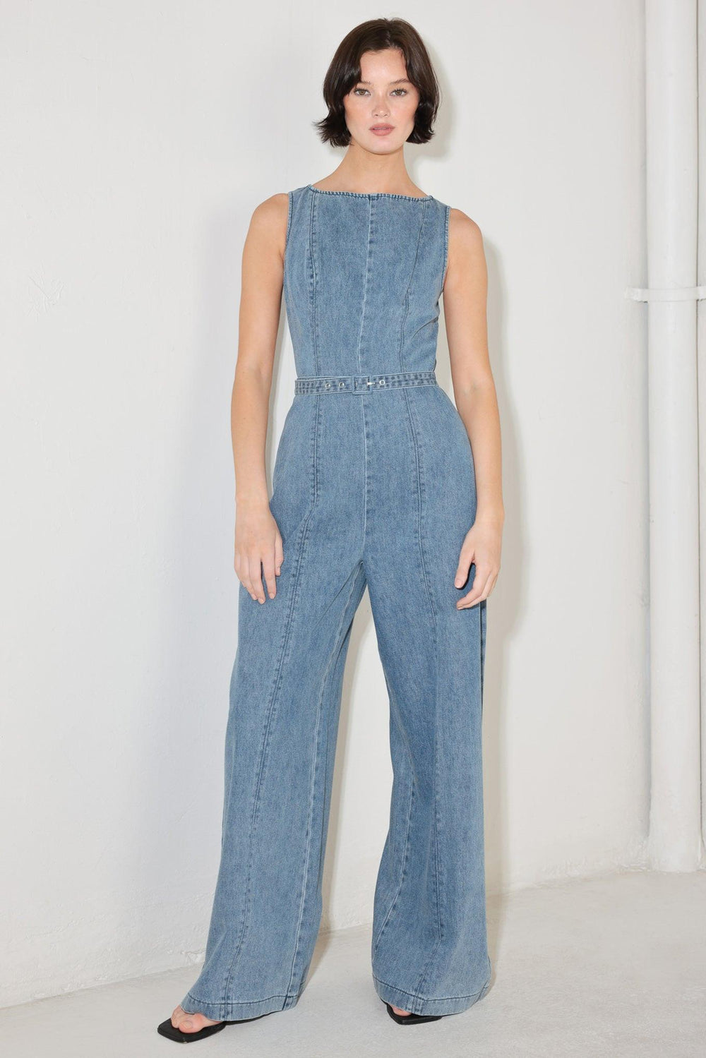 
A washed denim jumpsuit featuring wide neckline, sleeveless, self belt, wide leg and back zipper closure

Details:

Self : 90.2% Cotton 4.8% Viscose 5% Polyester

Size &amp; Fit

- Model is 5`8" And Wearing Size Small
- Measurements Taken From Size Small
- Approx. Length: 59"