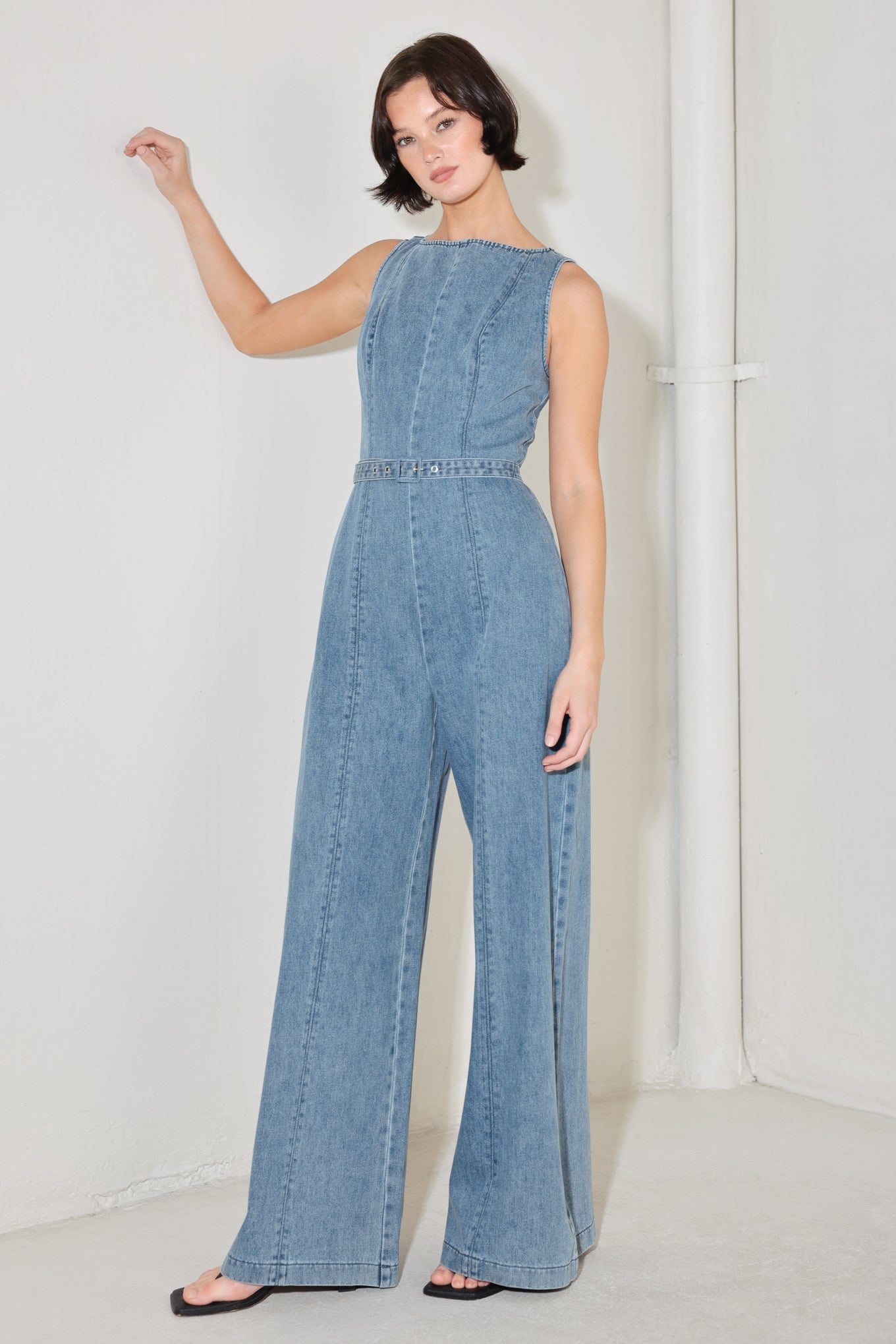 
A washed denim jumpsuit featuring wide neckline, sleeveless, self belt, wide leg and back zipper closure

Details:

Self : 90.2% Cotton 4.8% Viscose 5% Polyester

Size &amp; Fit

- Model is 5`8" And Wearing Size Small
- Measurements Taken From Size Small
- Approx. Length: 59"