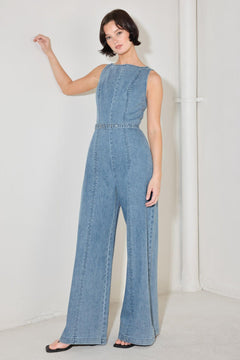 
A washed denim jumpsuit featuring wide neckline, sleeveless, self belt, wide leg and back zipper closure

Details:

Self : 90.2% Cotton 4.8% Viscose 5% Polyester

Size &amp; Fit

- Model is 5`8" And Wearing Size Small
- Measurements Taken From Size Small
- Approx. Length: 59"