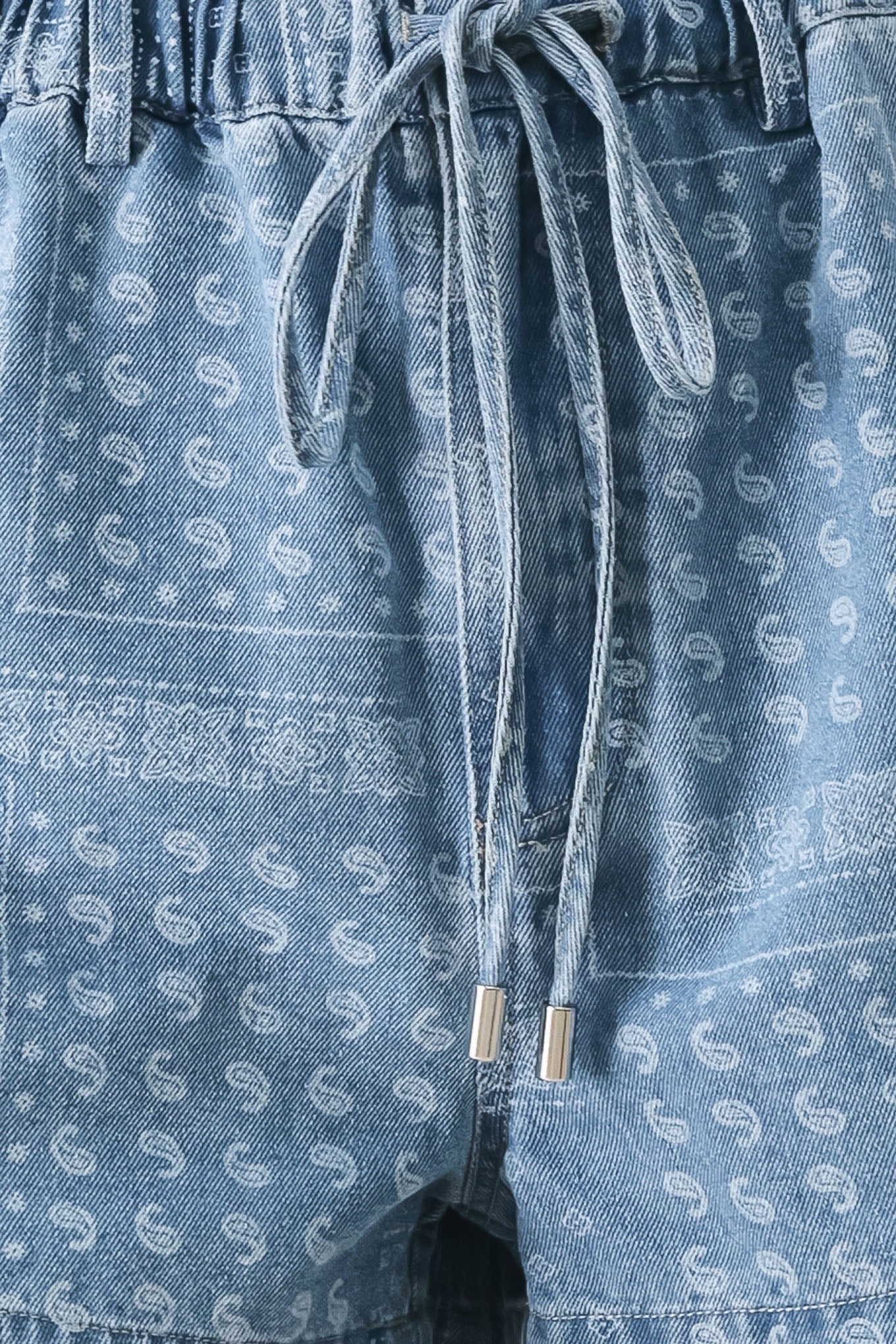 Close up of blue denim shorts with white paisley pattern and drawstring | FREEMARKET | Flying Tomato