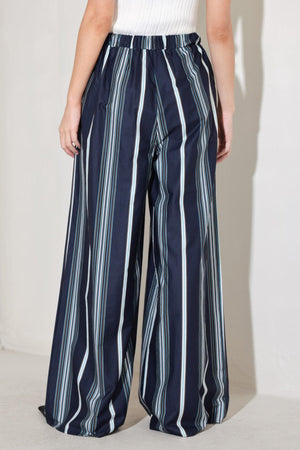 
A striped woven pant featuring front pleat, wide leg and elasticized back waistband. Matching top FT1821B

Details:

Self : 100% Cotton

Size &amp; Fit

- Model is 5`8" And Wearing Size Small
- Measurements Taken From Size Small
- Approx. Length: 44"