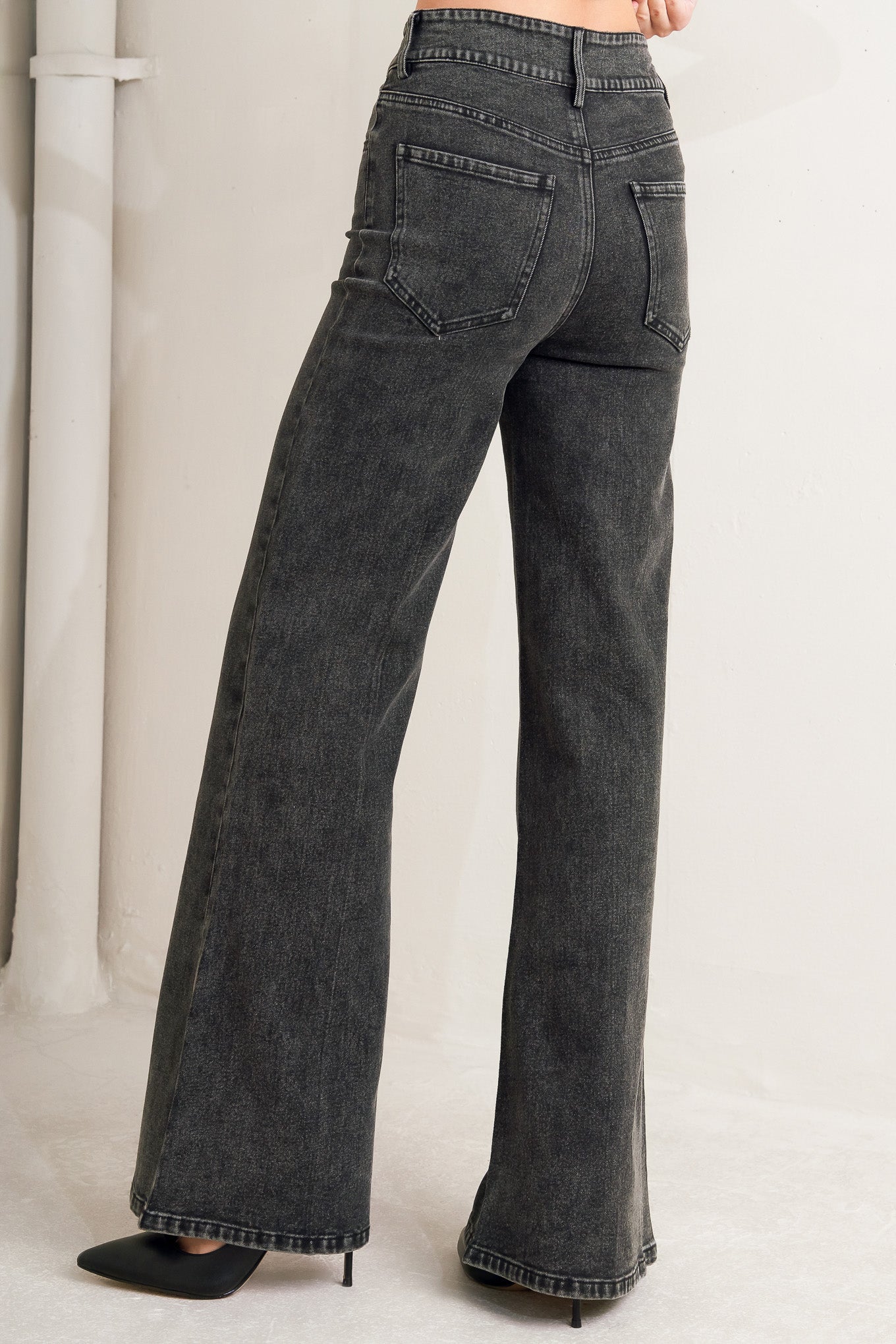 A washed denim pant featuring front closure, pockets, center leg seam and straight leg.