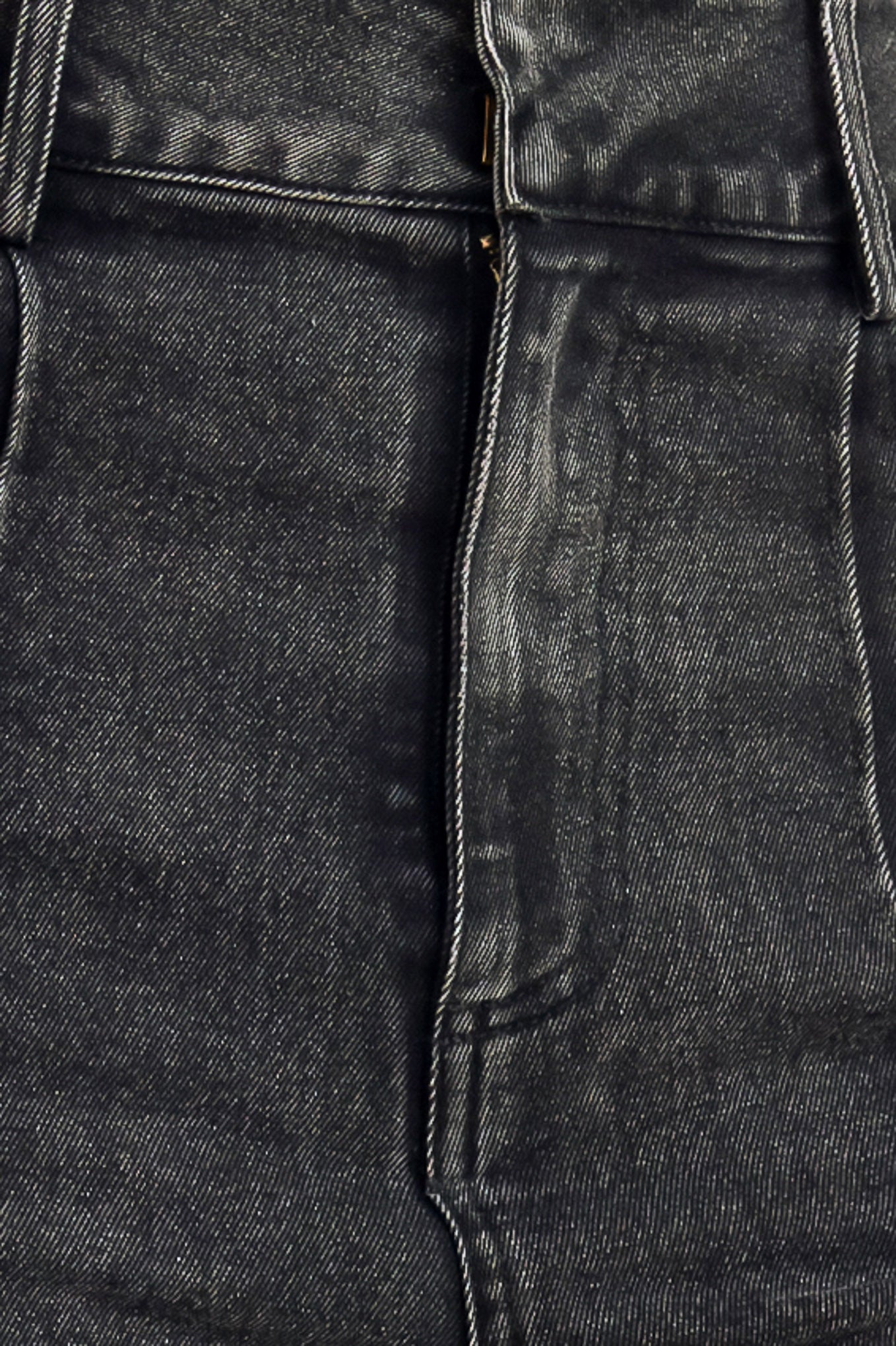 A washed denim pant featuring front closure, pockets, center leg seam and straight leg.