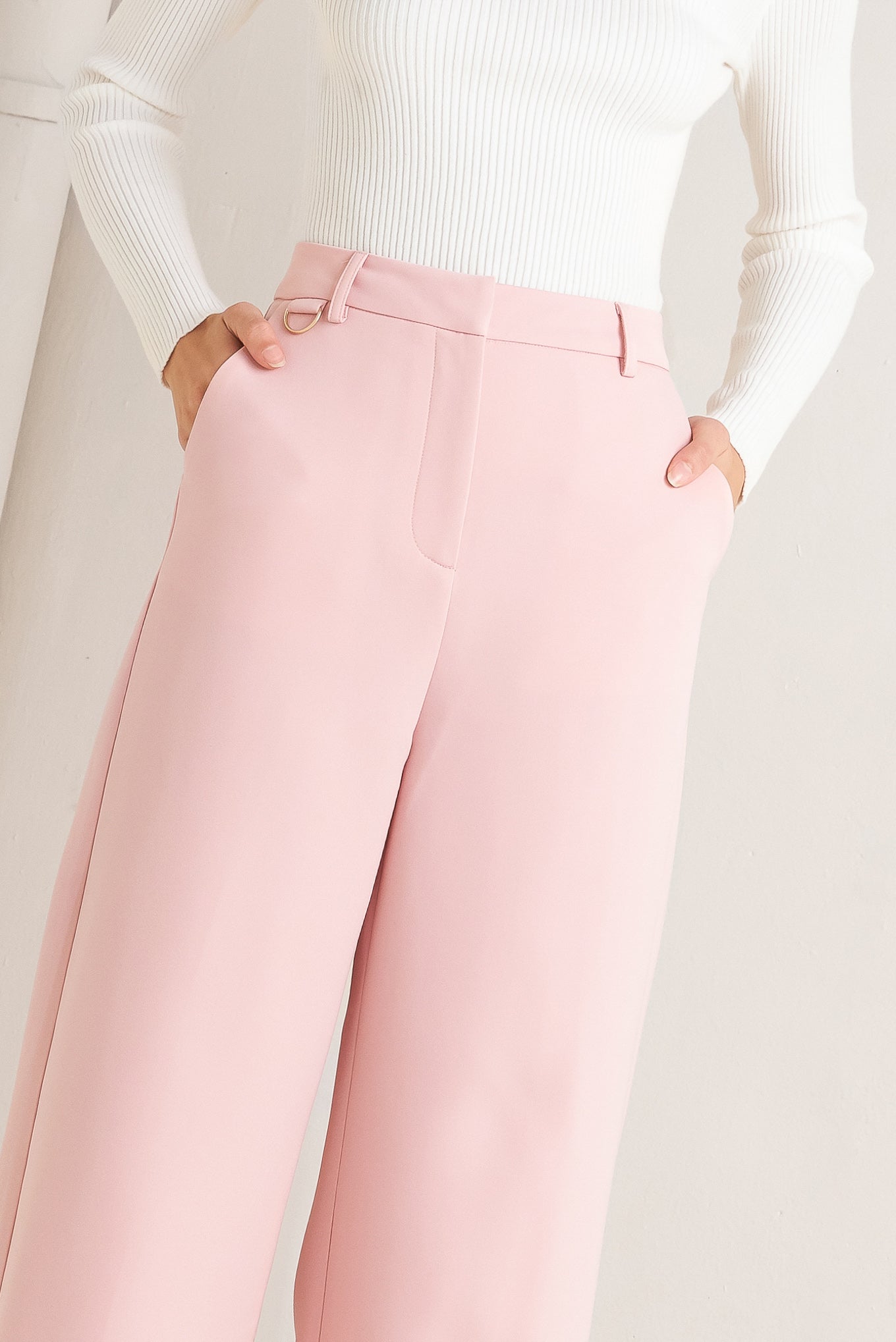 A solid woven pant featuring front closure, pockets and wide leg.