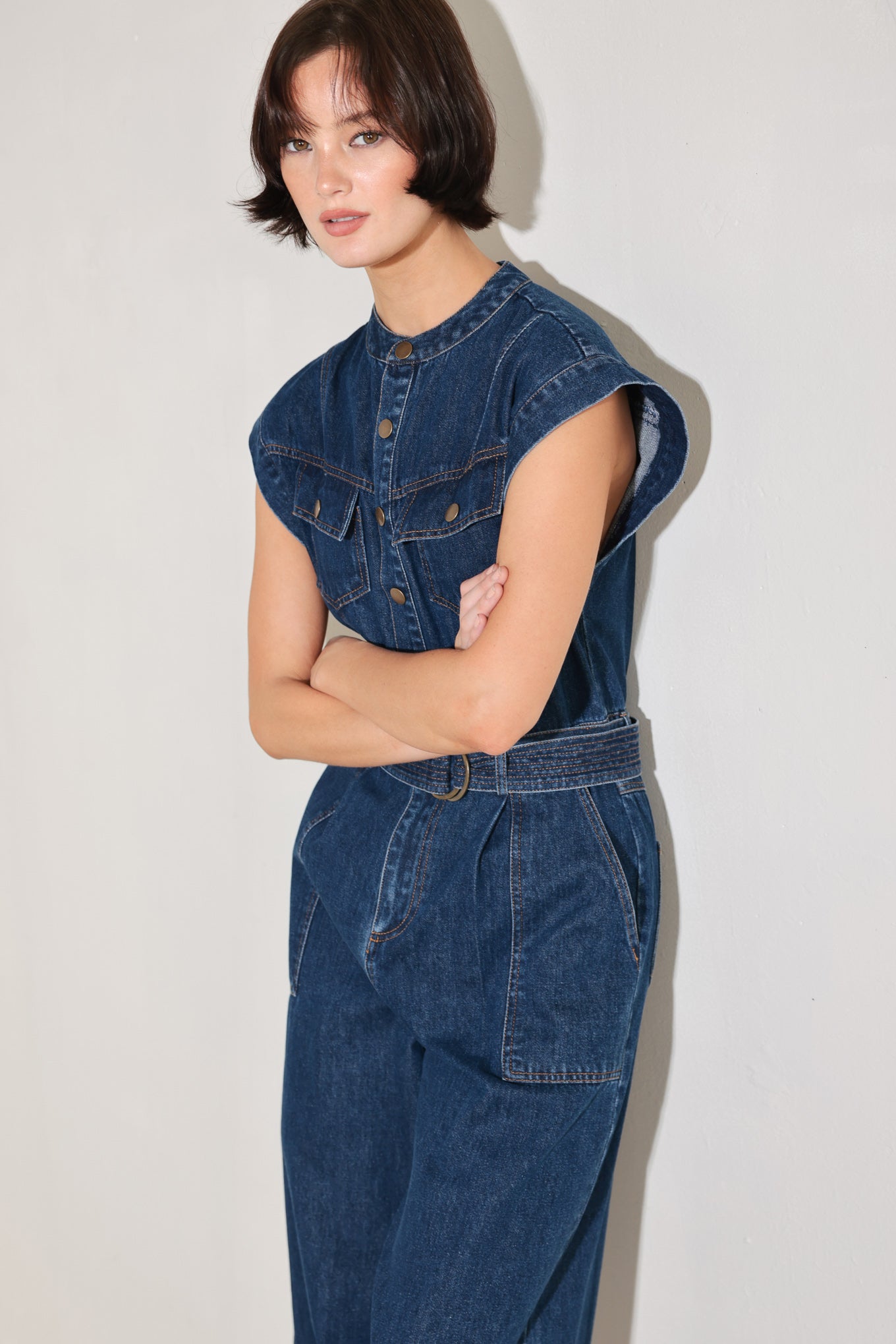 
A washed denim jumpsuit featuring front closure, short sleeve, pockets, stitched belt and wide leg

Details:

Self : 90% Cotton 10% Polyester

Size &amp; Fit

- Model is 5`8" And Wearing Size Small
- Measurements Taken From Size Small
- Approx. Length: 59"