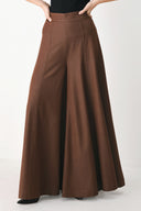 A model wearing high-waisted, wide-leg brown trousers | FREEMARKET