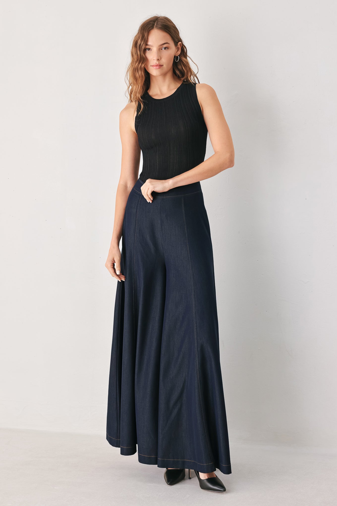 A model wearing high-waisted, wide-leg dark navy blue trousers | FREEMARKET