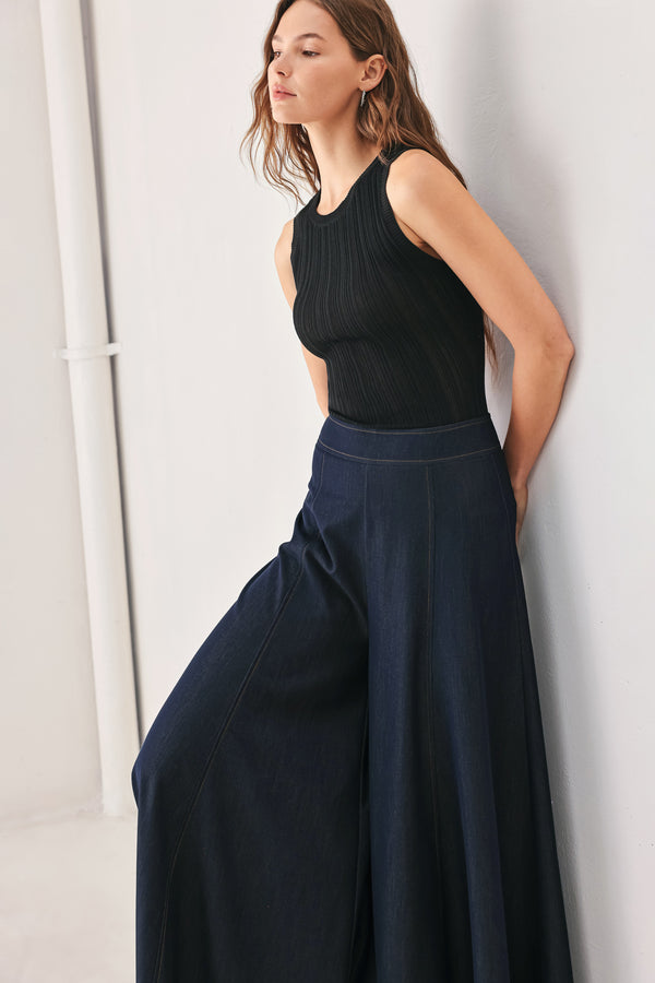 A model wearing high-waisted, wide-leg dark navy blue trousers | FREEMARKET