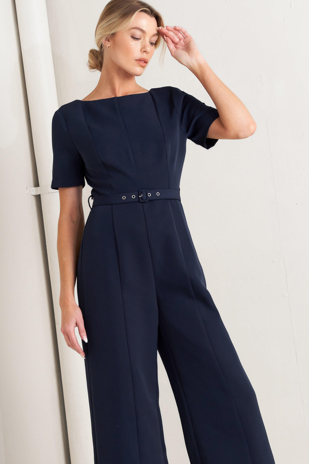 
A solid woven jumpsuit featuring wide neckline, short sleeve, self belt, wide leg, V back and zipper closure

Self : 95% Polyester 5% Spandex

Size &amp; Fit

- Model is 5`8" And Wearing Size Small
- Measurements Taken From Size Small
- Approx. Length: 60"