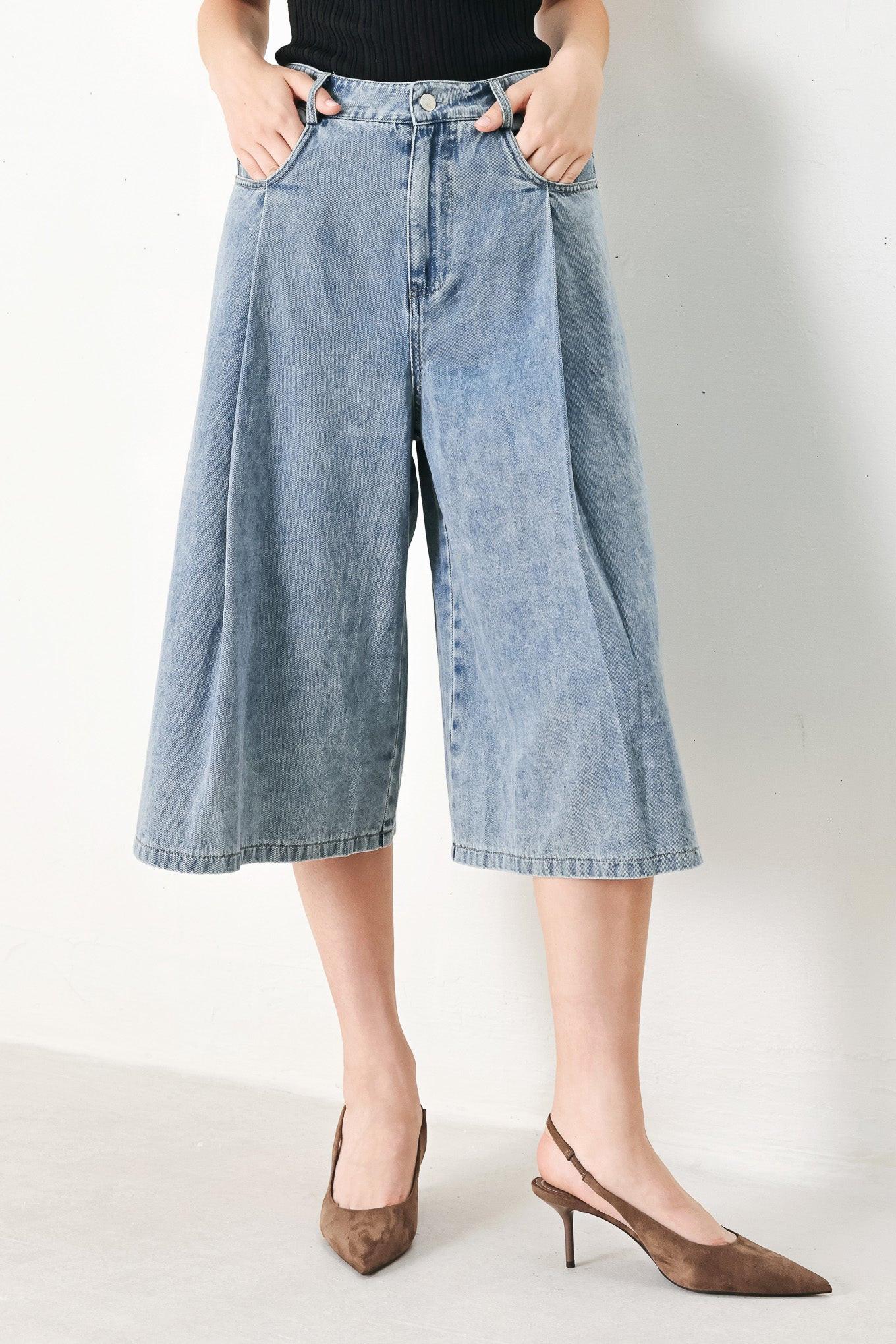 A washed denim culotte pant with side pockets and front closure