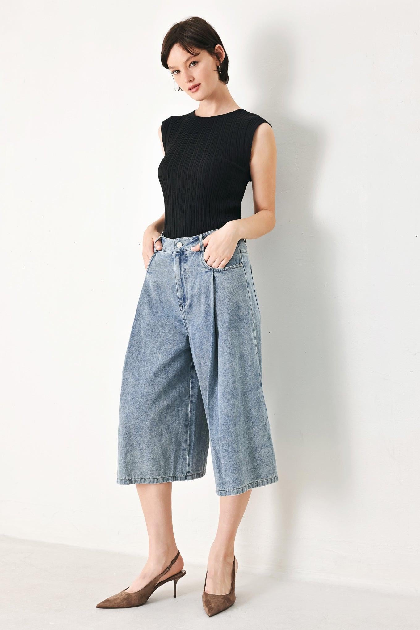 A washed denim culotte pant with side pockets and front closure