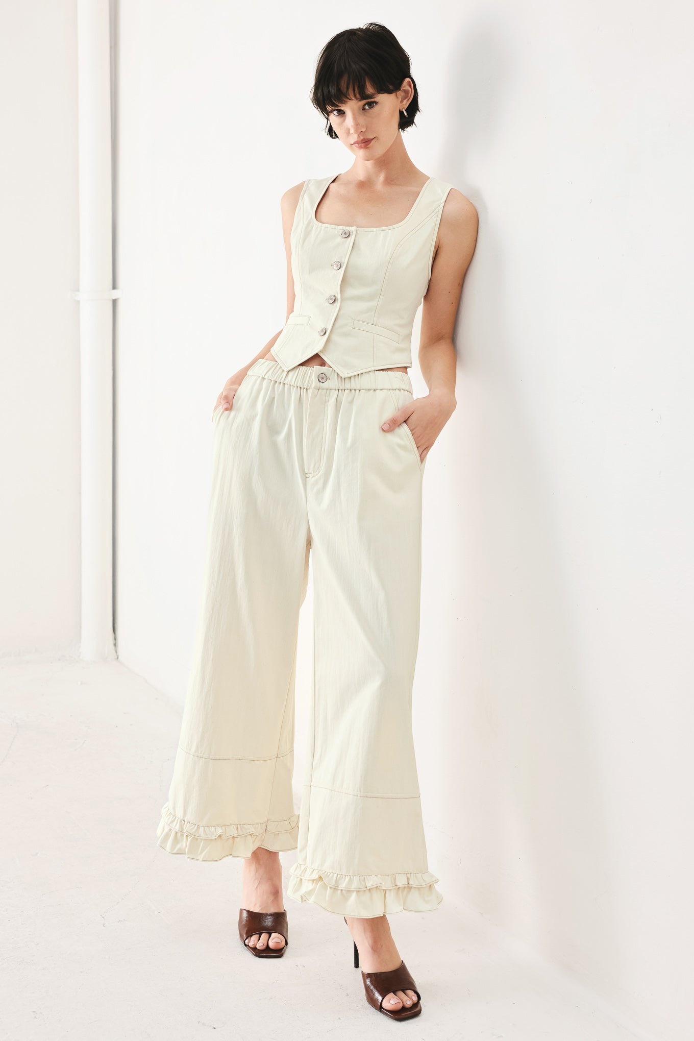 Woman wearing oatmeal culotte pants featuring elastic waist with front closure, side pockets and double ruffle hem | FREEMARKET