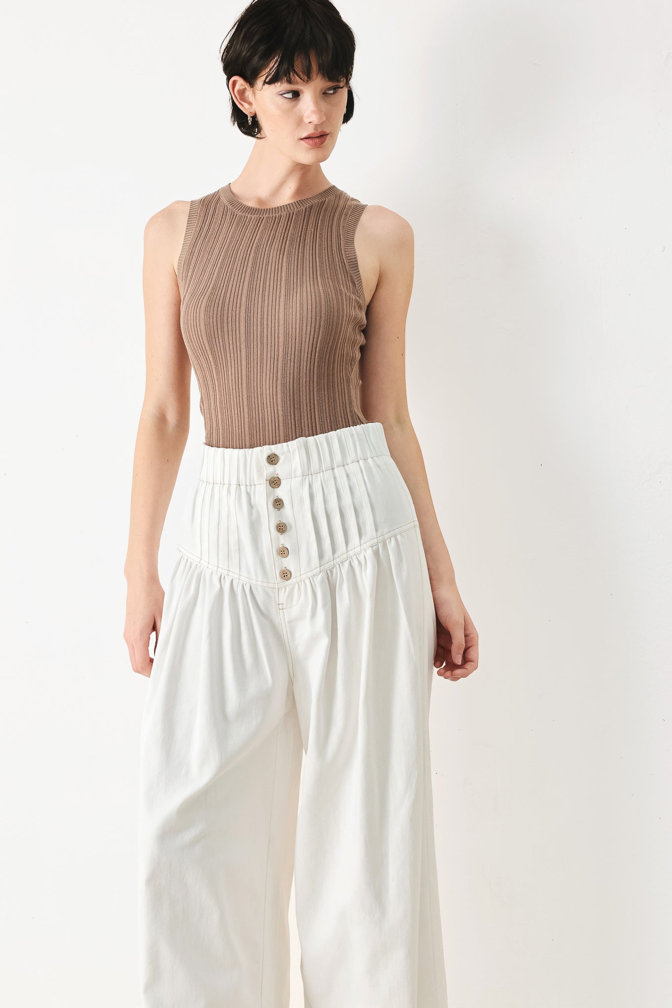 Woman wearing white solid woven pant with elastic waist band, front button closure, pintuck detail and wide leg | FREEMARKET