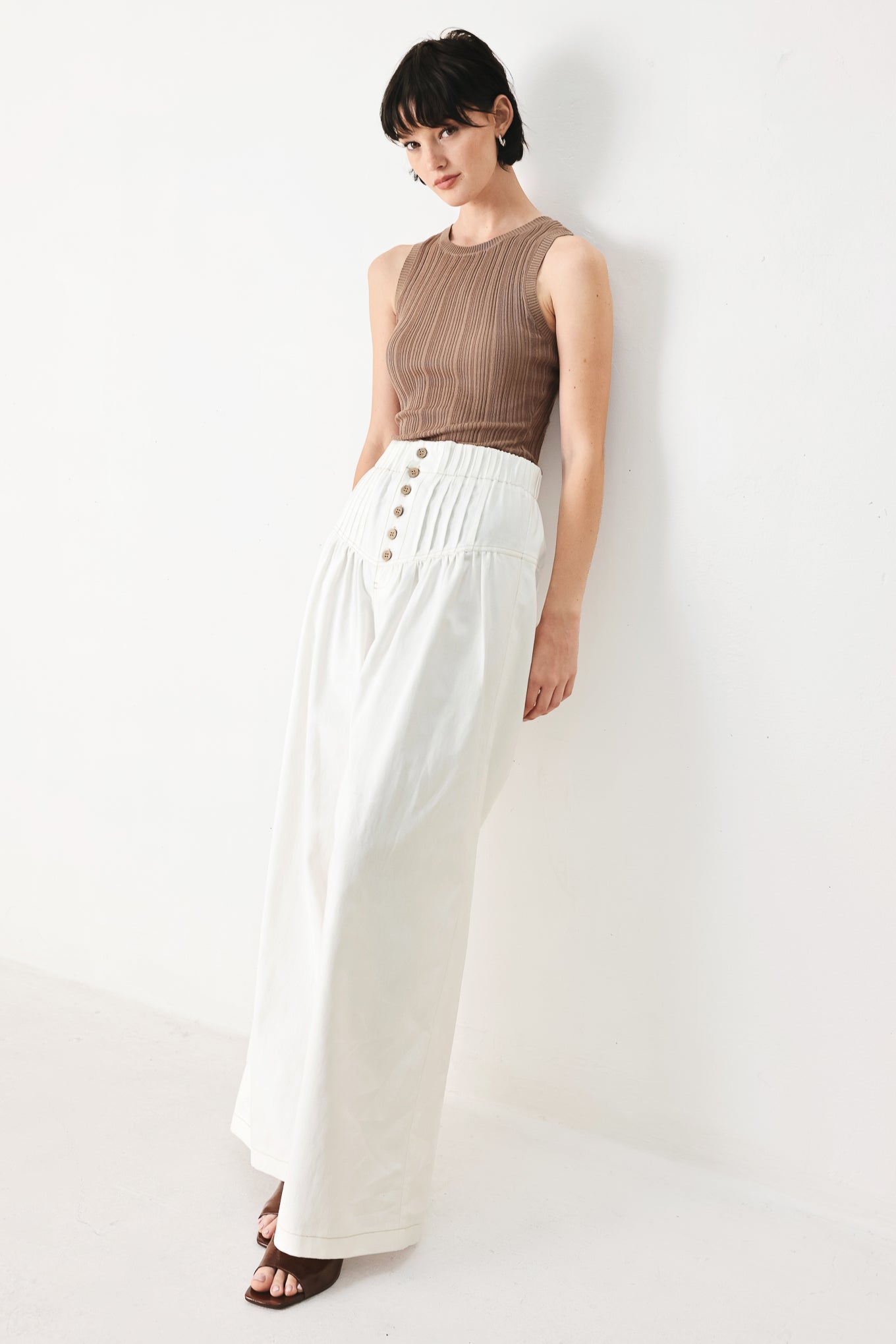 Woman wearing white solid woven pant with elastic waist band, front button closure, pintuck detail and wide leg | FREEMARKET