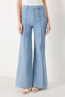 Woman wearing light blue boot cut pant with front closure | FREEMARKET | Flying Tomato