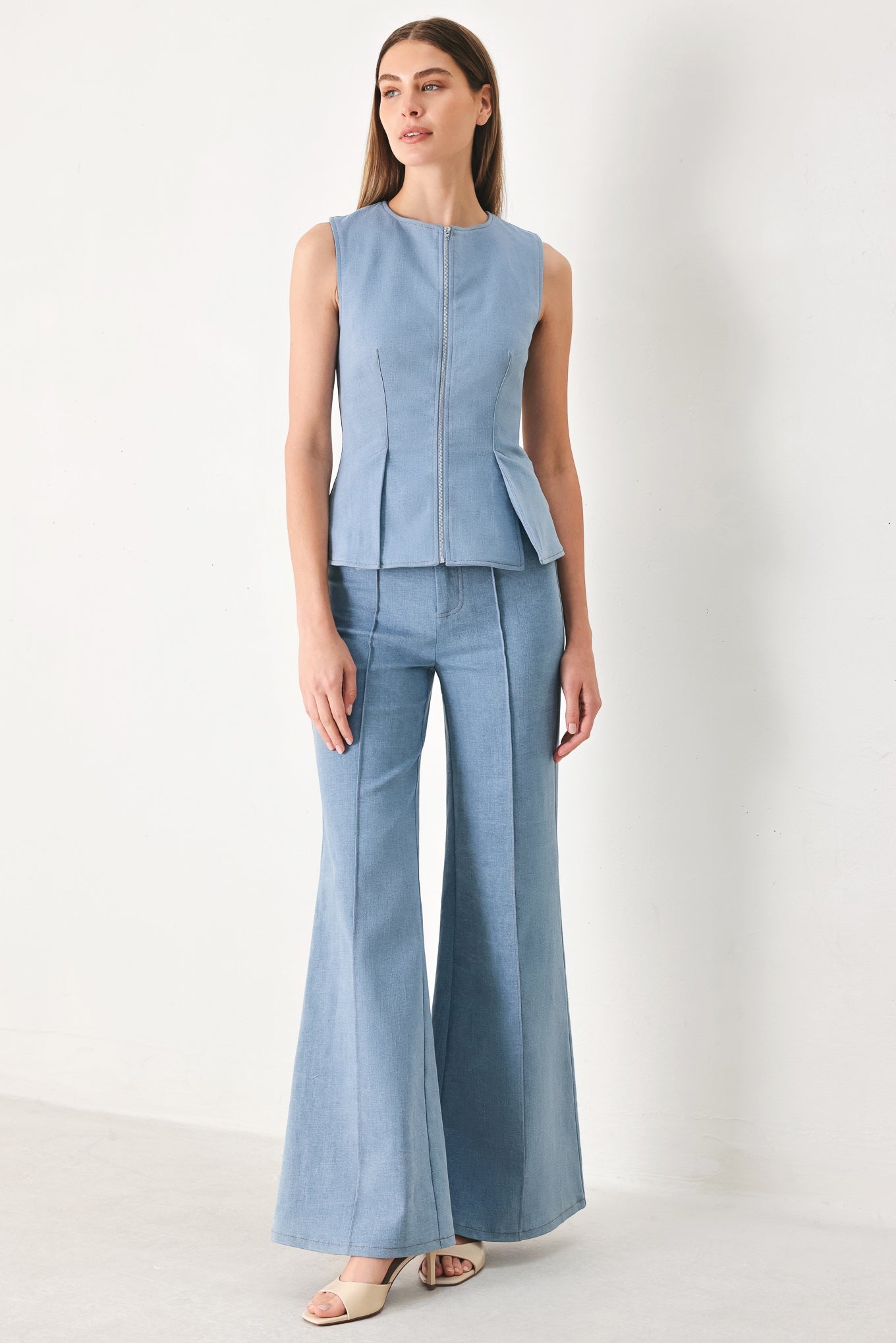 Woman wearing light blue boot cut pants with front closure | FREEMARKET | Flying Tomato
