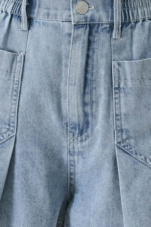 Close up of a washed light denim short featuring elastic waist, front closure, front pockets and pleats with wide leg | FREEMARKET