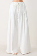 Woman wearing white wide-leg pants | FREEMARKET