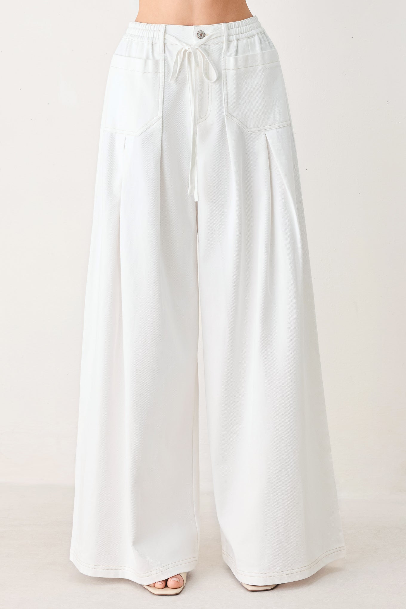 Woman wearing white wide-leg pants | FREEMARKET