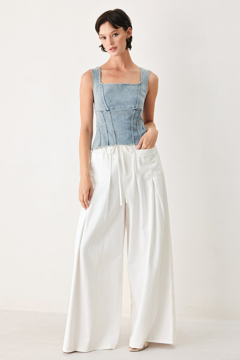 Woman wearing white wide-leg pants | FREEMARKET