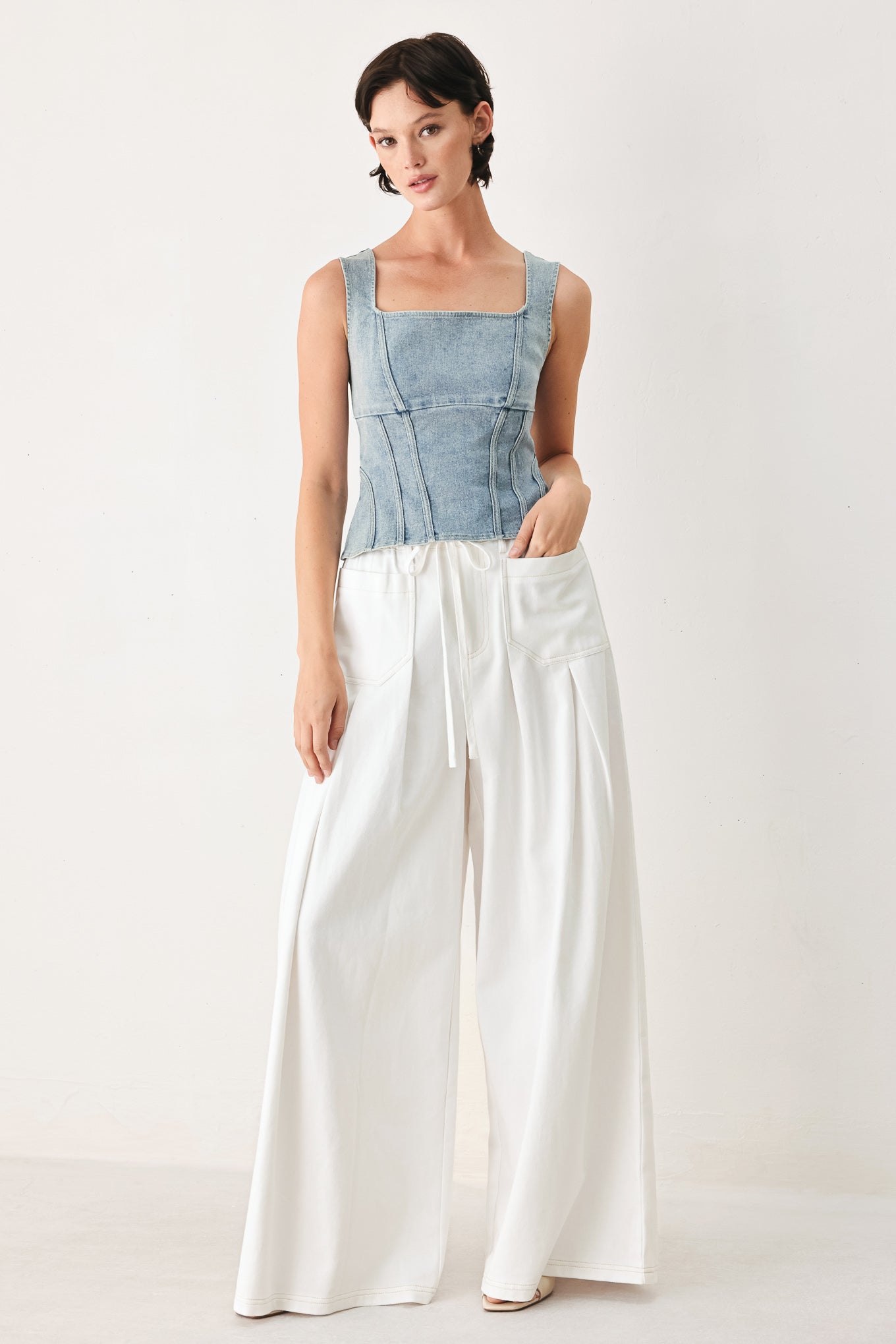 Woman wearing white wide-leg pants | FREEMARKET