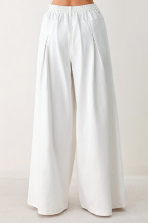 Woman wearing white wide-leg pants | FREEMARKET