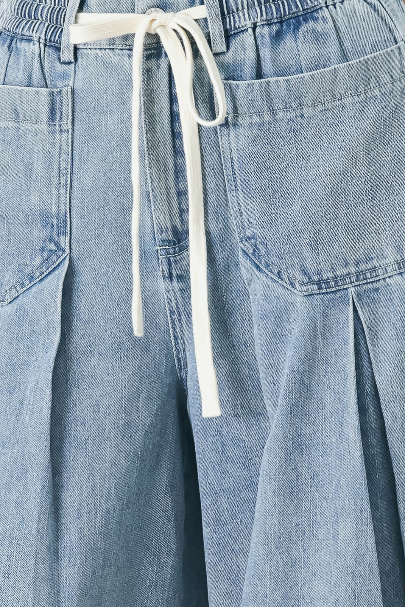 Woman wearing a light blue denim wide-leg pants with a drawstring waist | FREEMARKET