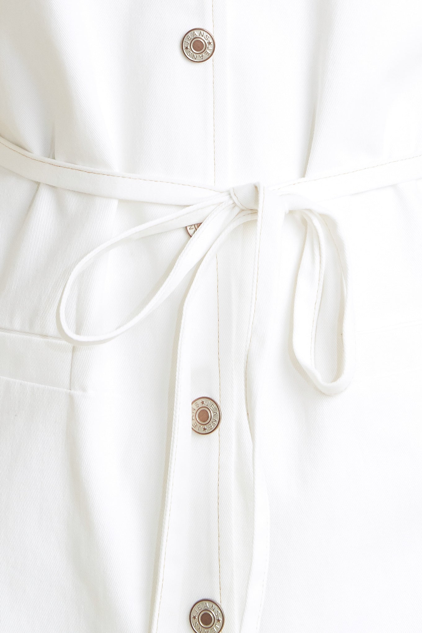 A solid woven romper featuring V neckline, sleeveless, front button down, pockets and skinny self belt

Details:

Self: 100% Cotton

Size & Fit

- Model is 5`8" And Wearing Size Small
- Measurements Taken From Size Small
- Approx. Length: 33"