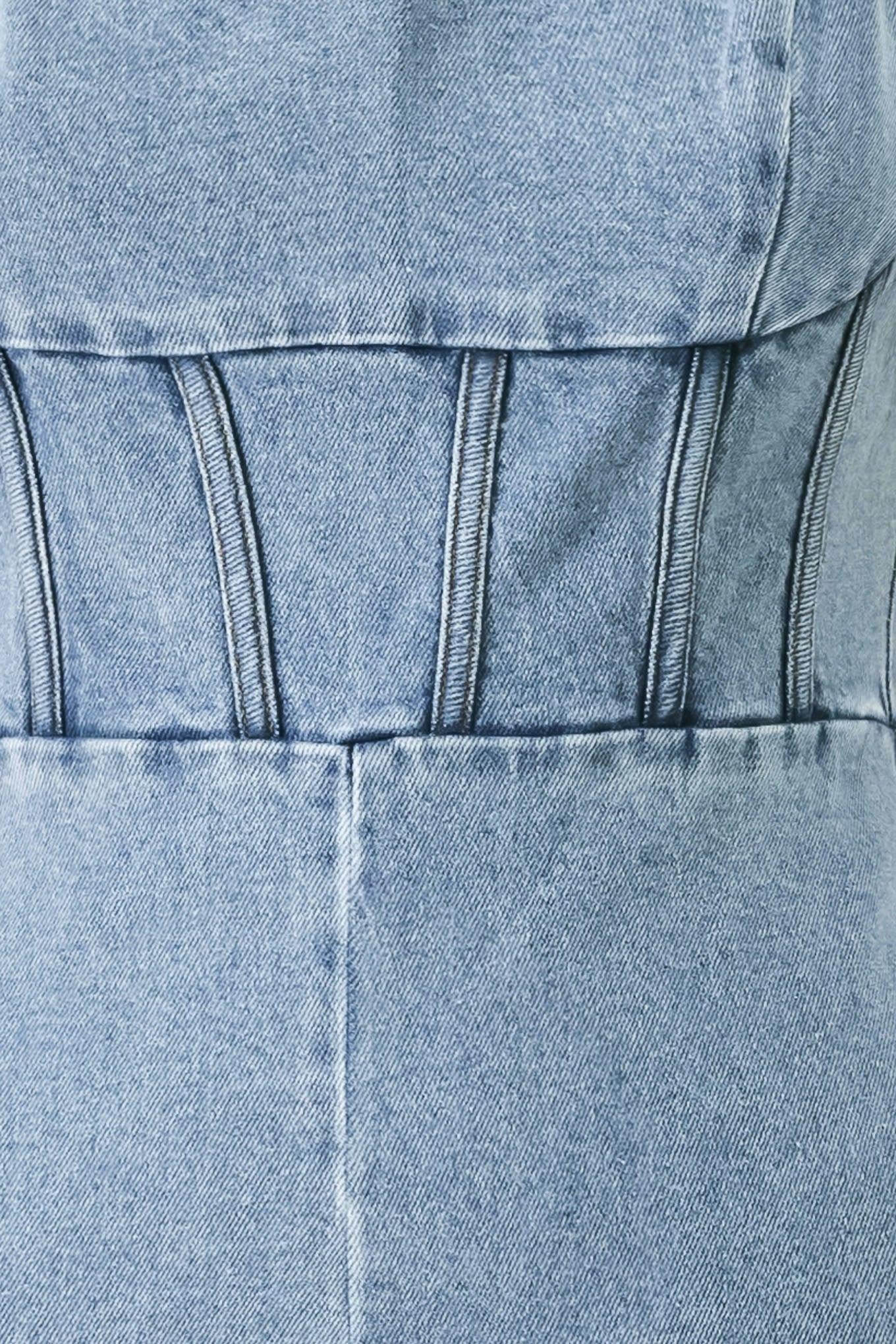 A washed denim jumpsuit featuring U neckline, straps, waist yoke, wide leg, bare back with zipper closure