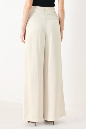Woman wearing ivory woven wide-leg pants with front closure and pleated front | FREEMARKET