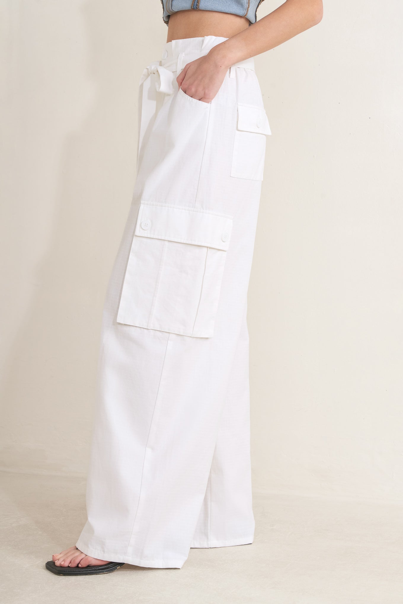 Woman wearing white wide-leg cargo pants with sash tie | FREEMARKET | Flying Tomato