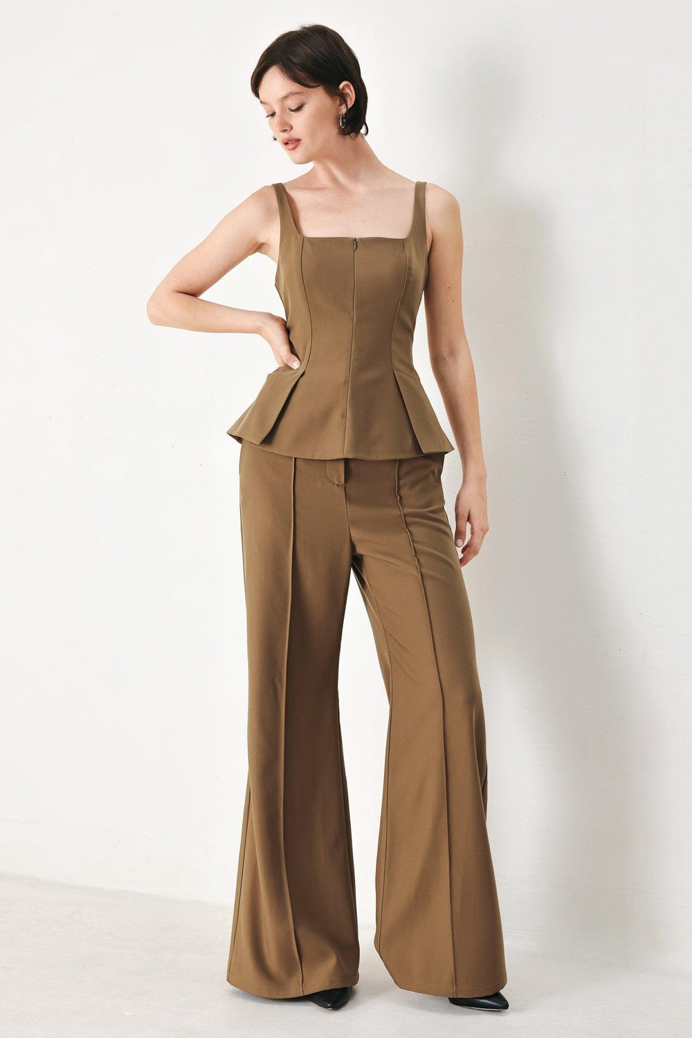 A solid woven pant with front closure and wide leg.