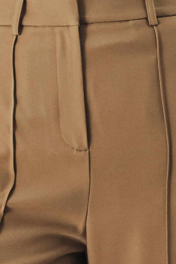 A solid woven pant with front closure and wide leg.