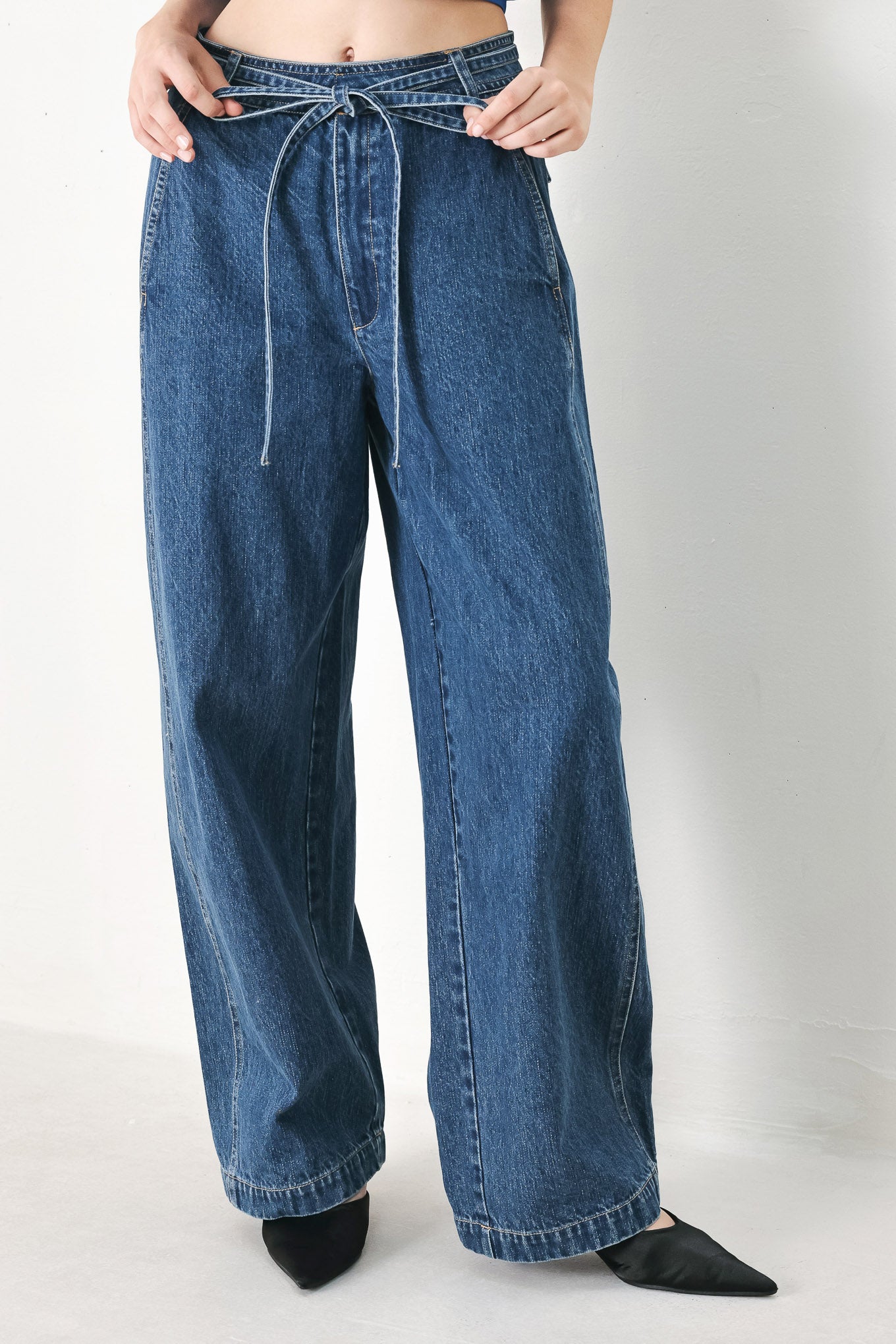 A washed oversized denim pant featuring front closure, side/back pockets and wide leg