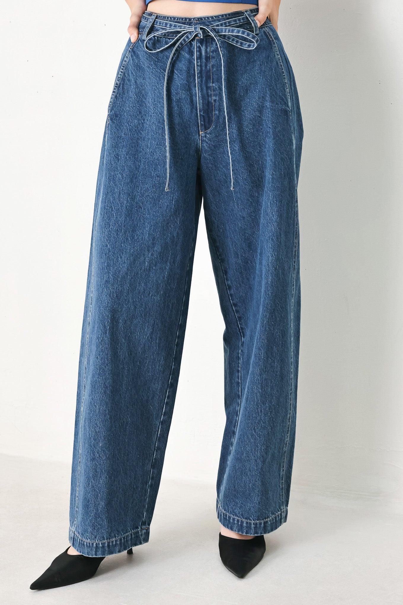 A washed oversized denim pant featuring front closure, side/back pockets and wide leg