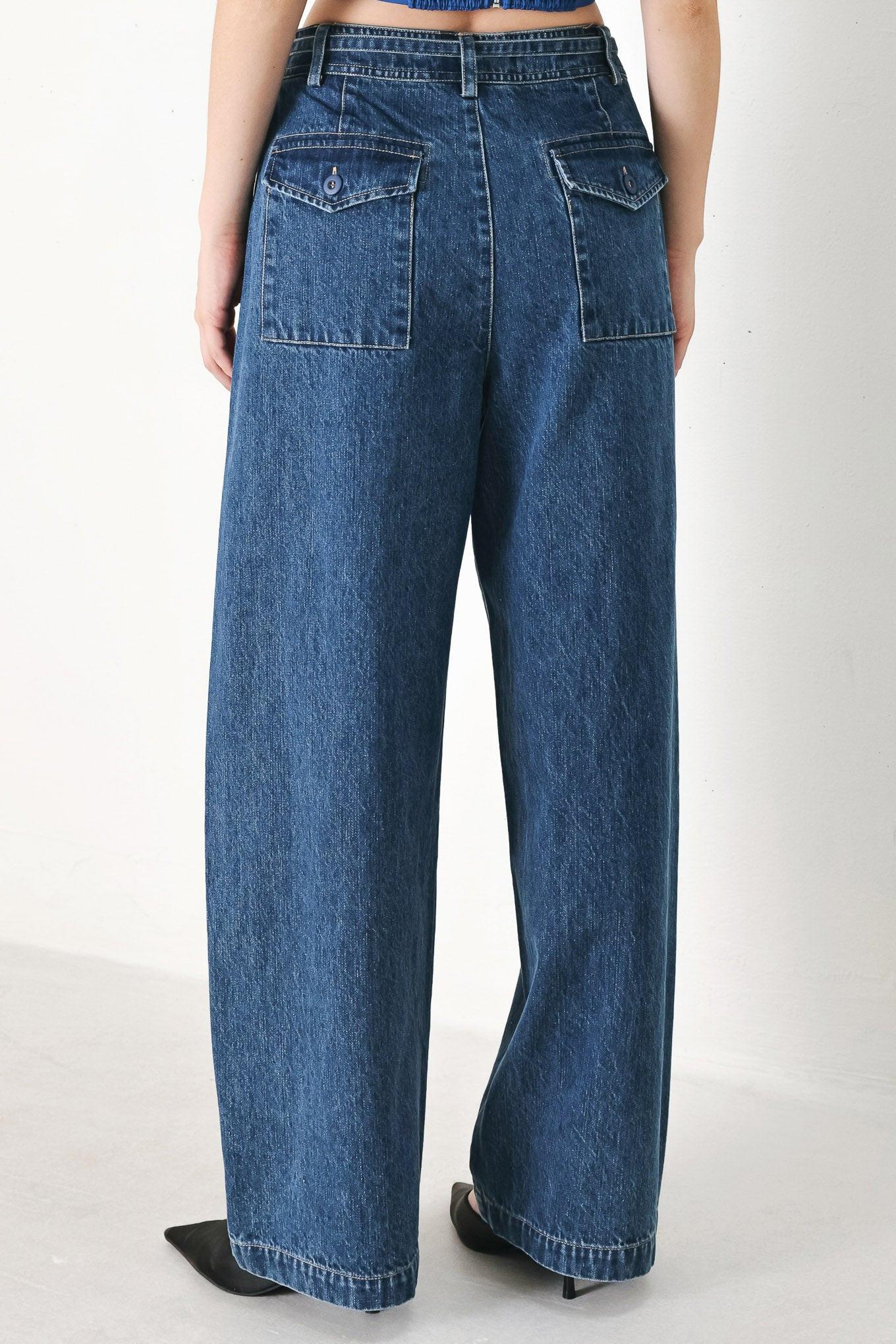 A washed oversized denim pant featuring front closure, side/back pockets and wide leg