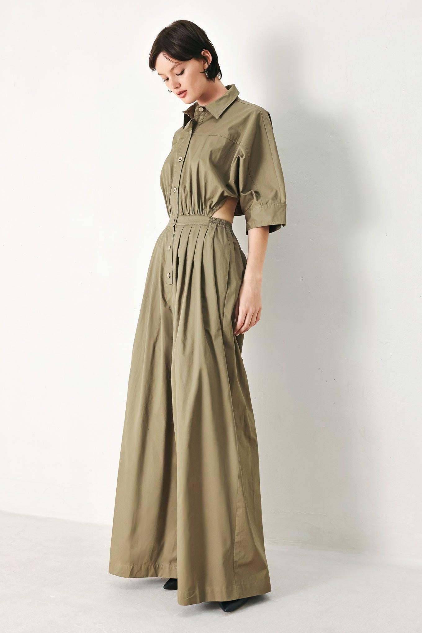A solid woven matching utility-style jumpsuit consisting of a cropped, button-up shirt and high-waisted, wide-leg trouser