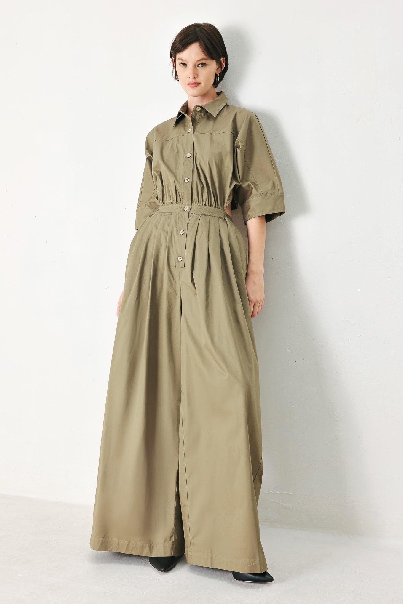 A solid woven matching utility-style jumpsuit consisting of a cropped, button-up shirt and high-waisted, wide-leg trouser
