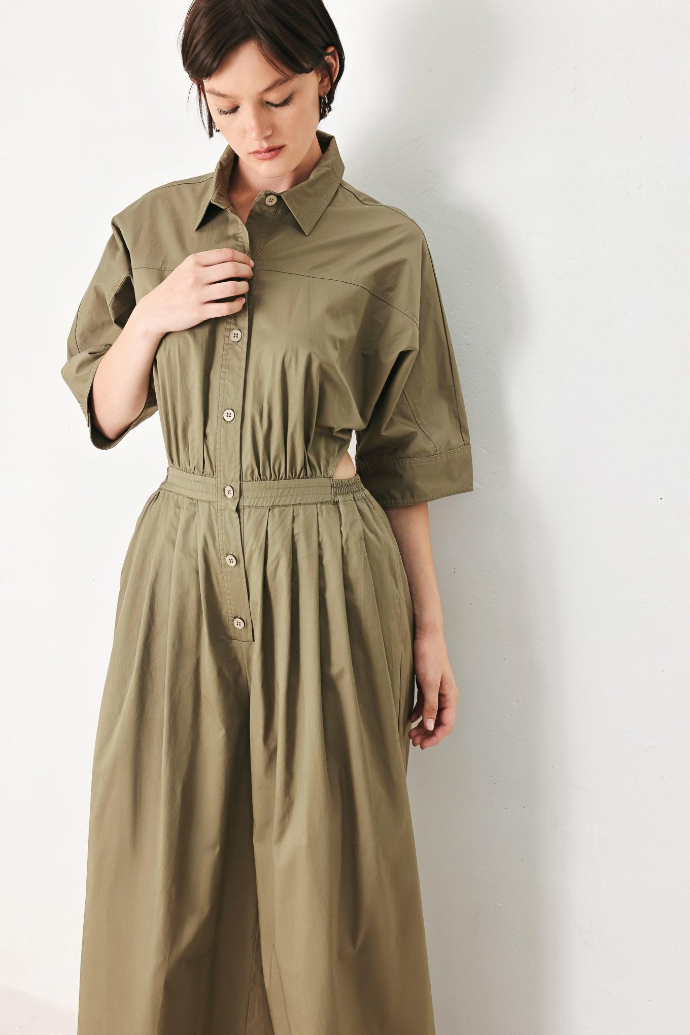 A solid woven matching utility-style jumpsuit consisting of a cropped, button-up shirt and high-waisted, wide-leg trouser