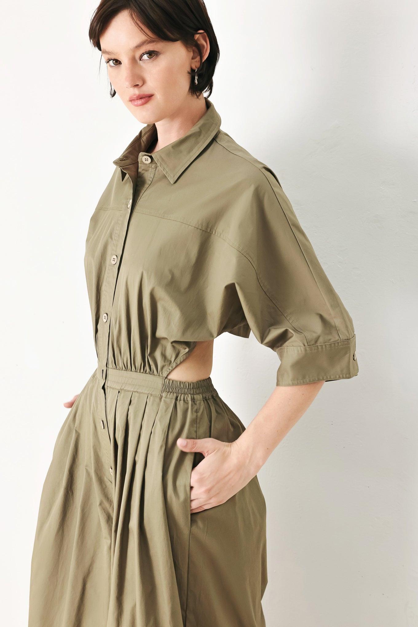 A solid woven matching utility-style jumpsuit consisting of a cropped, button-up shirt and high-waisted, wide-leg trouser
