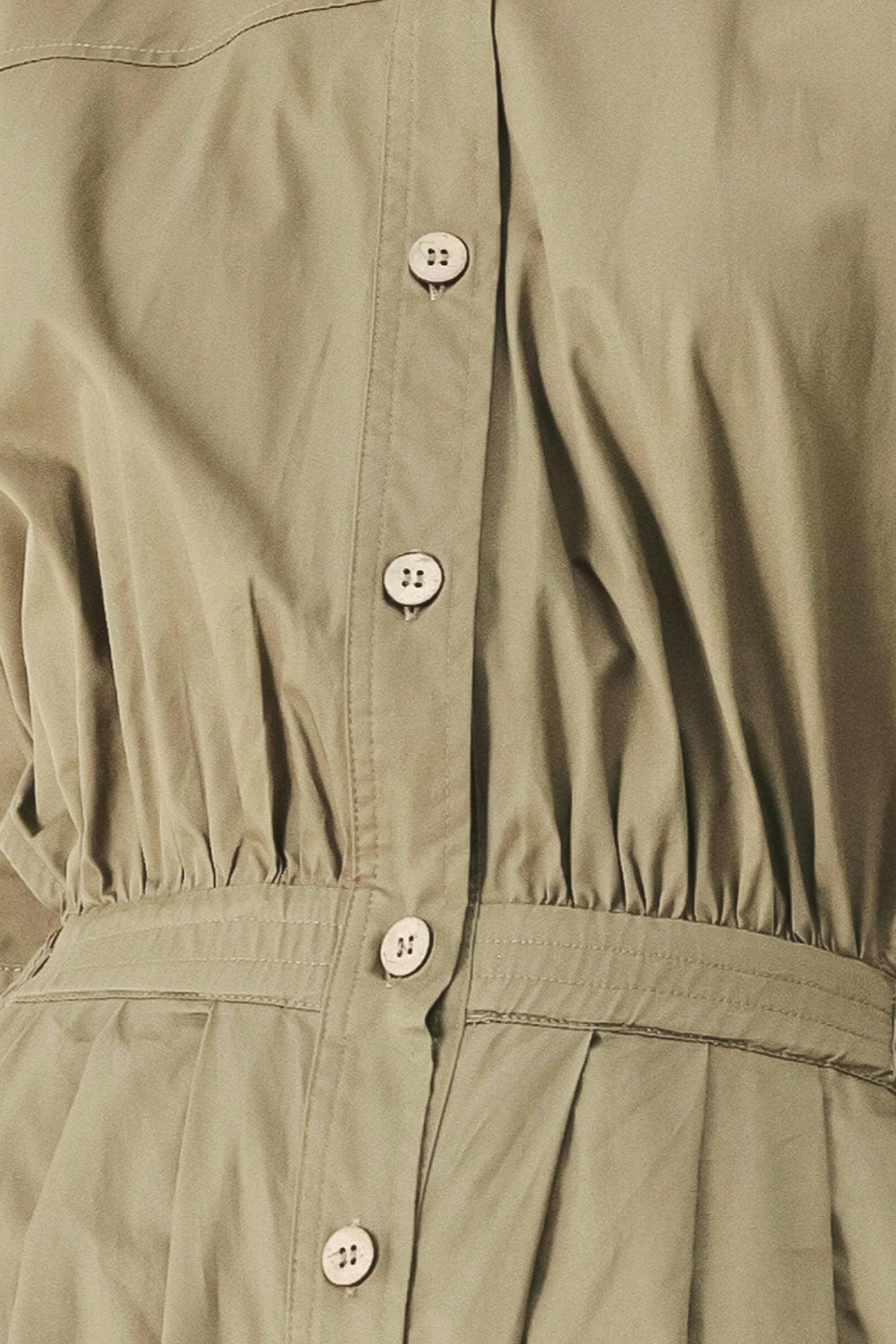 A solid woven matching utility-style jumpsuit consisting of a cropped, button-up shirt and high-waisted, wide-leg trouser